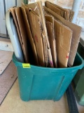 Storage tote with boxes on back porch