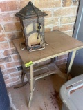 Metal table and broken lantern bird feeder on back porch