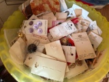 Plastic bowl full of multiple variety of buttons