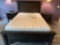 Queen bed with headboard, two nightstands, two chest of drawers, and a corner wall cabinet, sleep