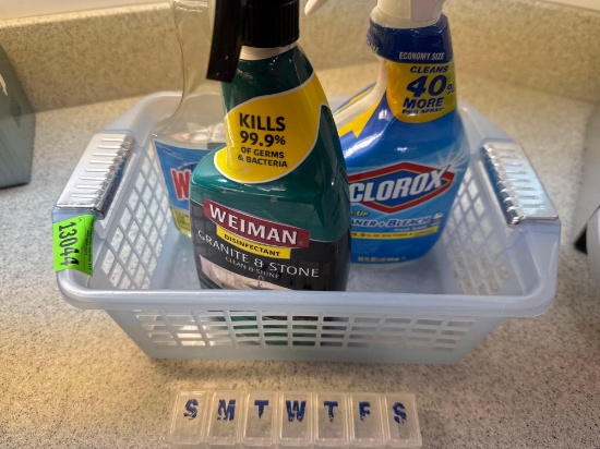 Cleaning supplies, plastic basket, and pill organizer