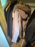 Several different coats or outdoor jackets