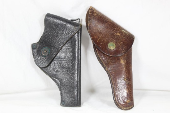 Two US leather pistol holsters. Used. Right handed.