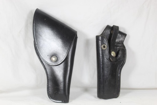 Two black leather holsters. One Dan Hume, right handed and one unknown left handed. In good