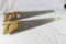 Two large wood handled hand crosscut saw. Used in good condition.