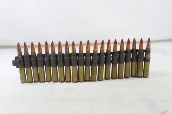 Link belt with 20 rounds of red tip ammo of unknown caliber