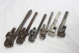 Bag of five small size pipe wrenches. Used.