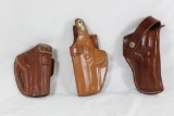 Three leather holsters. One Bianchi left handed 3