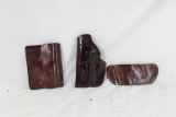 Three leather holsters. One Mitch Rosen left handed clip for small revolver, one Don Hume right
