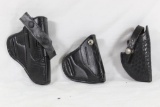 Three black leather holsters. One S&W tooled for 1-2