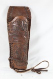 One tooled brown leather single band right handed western holster. Used in good condition.