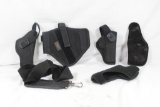 Bag of three nylon holsters and two soft rubber felt lined holsters. Two right handed nylon and one