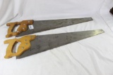 Two large wood handled hand crosscut saw. Used in good condition.