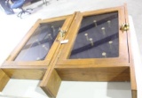 Two wood and glass door wall velvet lined pistol display cases. Used in very good condition. 32