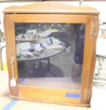 Wall wood and glass door Display case with hooks, copper colored hinges and lock with key. Used in