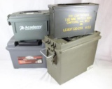 Three green plastic ammo boxes like new and one 5.56 metal ammo box, used.