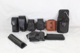 Miscellaneous leather and nylon magazine pouches, handcuff holder, etc. Most are like new.