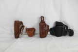 One brown leather left handed leather snap holster for 1911, one black 2 position right handed