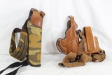 Two shoulder holsters, one brown leather and one camo nylon. In good condition.