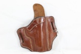 One brown right handed leather holster with trigger pad. Used in good condition.