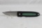 Single blade Buck folding liner lock hunter with 3.25 inch partially serrated blade. Black and green