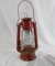 One red kerosene lamp lantern. Used in fair to poor condition. Appears to work as it should.