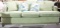 One 6 1/2 foot lt green colored couch with two matching pillows and two blue bird pillows. No tears,