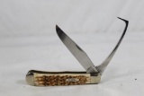 Case XX Equestrian with 3.25 inch blade and hoof pick. Jigged amber bone scales. New in box.