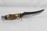 Kissing Crane sheath knife with 5 inch skinning blade, stag handle and original leather sheath. Used