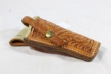 One Bridgeport Leather elk hide lined tooled leather small pistol holster. Used, but in very good