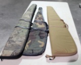 Three rifle cases with zippers.