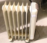 One upright oil heater on wheels. Used.