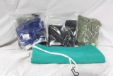 Four miscellaneous items. One nylon backed swimming raft, one nylon plastic rain suit, and two bags