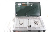 One Coleman two burner propane camp stove in plastic zippered carry case with two propane bottles.