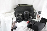 One nylon Canon camera shoulder bag with Canon camera two lens, two flashlights and one camera