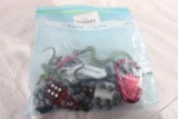 Three bags of small items and childrens plastic frogs and lizards.