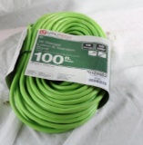 One 100 ft light green extension cord. New.