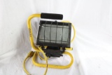 One yellow electric portable halogen work lamp. Used.