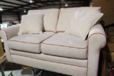 One six foot loveseat couch with two matching pillows. Cream color, no stains, no tears. Used in