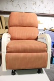 One burnt orange Wicker padded rocker/recliner. No tears, slight stain at top of chair. Used in nice