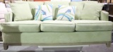 One 6 1/2 foot lt green colored couch with two matching pillows and two blue bird pillows. No tears,