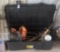 Tote with various items, including hedge trimmers, bar oil and chains