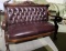 Burgundy leather 5 piece seating. Settee, rocker, one larger chair and 2 smaller chairs