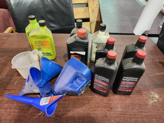 4 bottles of small engine oil, 2 partial quarts of auto transmission fluid, bar and chain oil and 4
