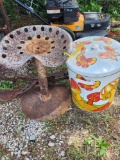 Chair made from old tractor seat, antique push plow and metal can