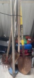 Various yard tools including shovels, rake and hoe