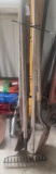 Various yard tools including pitch fork, shovels and rake