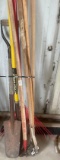 various yard tools including sharp shooter, hoe, leaf rake shop broom