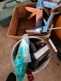 Bucket of miscellaneous items including weather stripping, caulking guns and paint scrapers