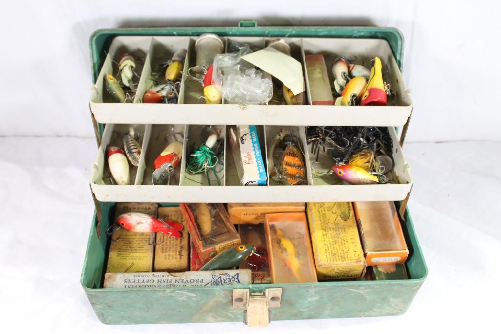 One green Plano fishing tackle box full of